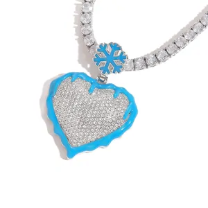 Pendant necklace: a heart set with small clear stones and edged in blue, on a chain of clear stones