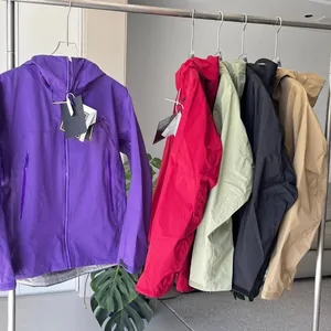 A purple zip jacket and four lightweight jackets in red, pale green, black and beige on a clothes rail